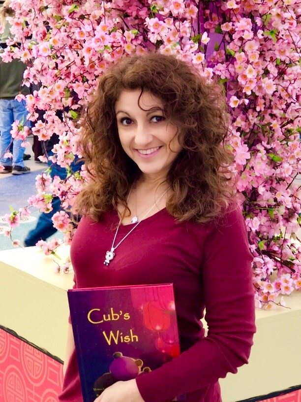 Author Angie Flores at Universal Studios Hollywood with her book Cub's Wish